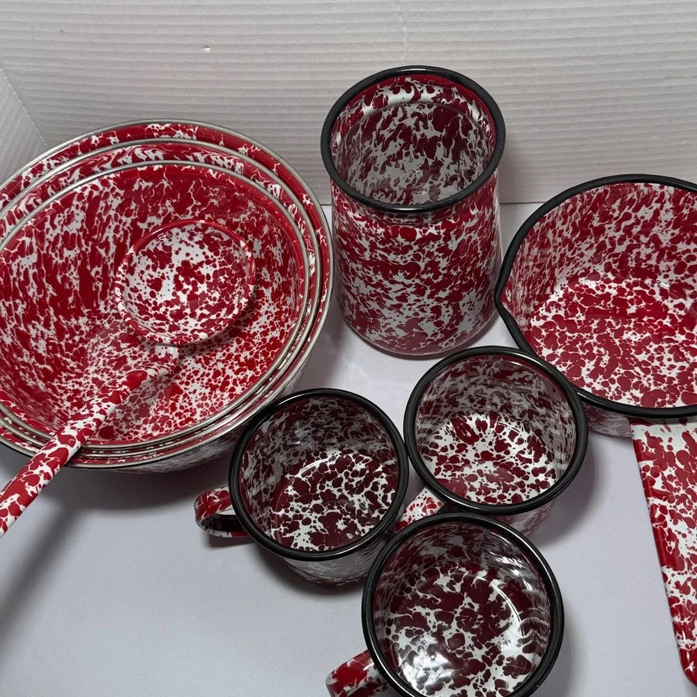 Vintage enameled tableware set with red splashes: rustic kitchen decoration
